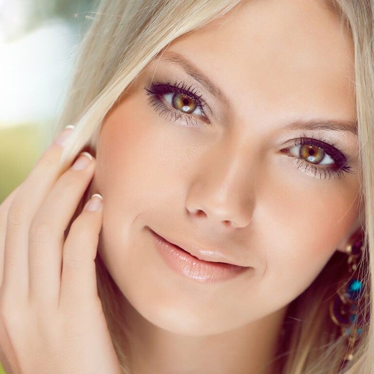 A beautiful blonde woman with long hair and green eyes.