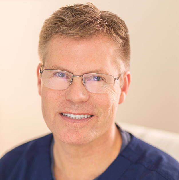 A man with glasses and a blue shirt