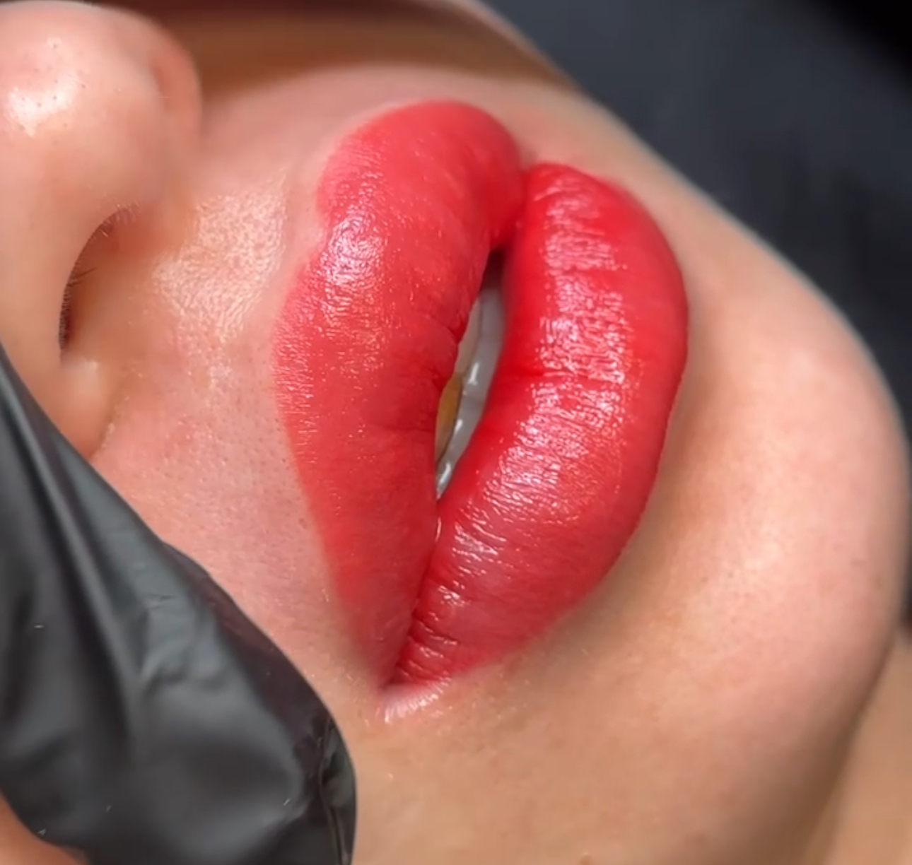 A woman with red lipstick on her lips.