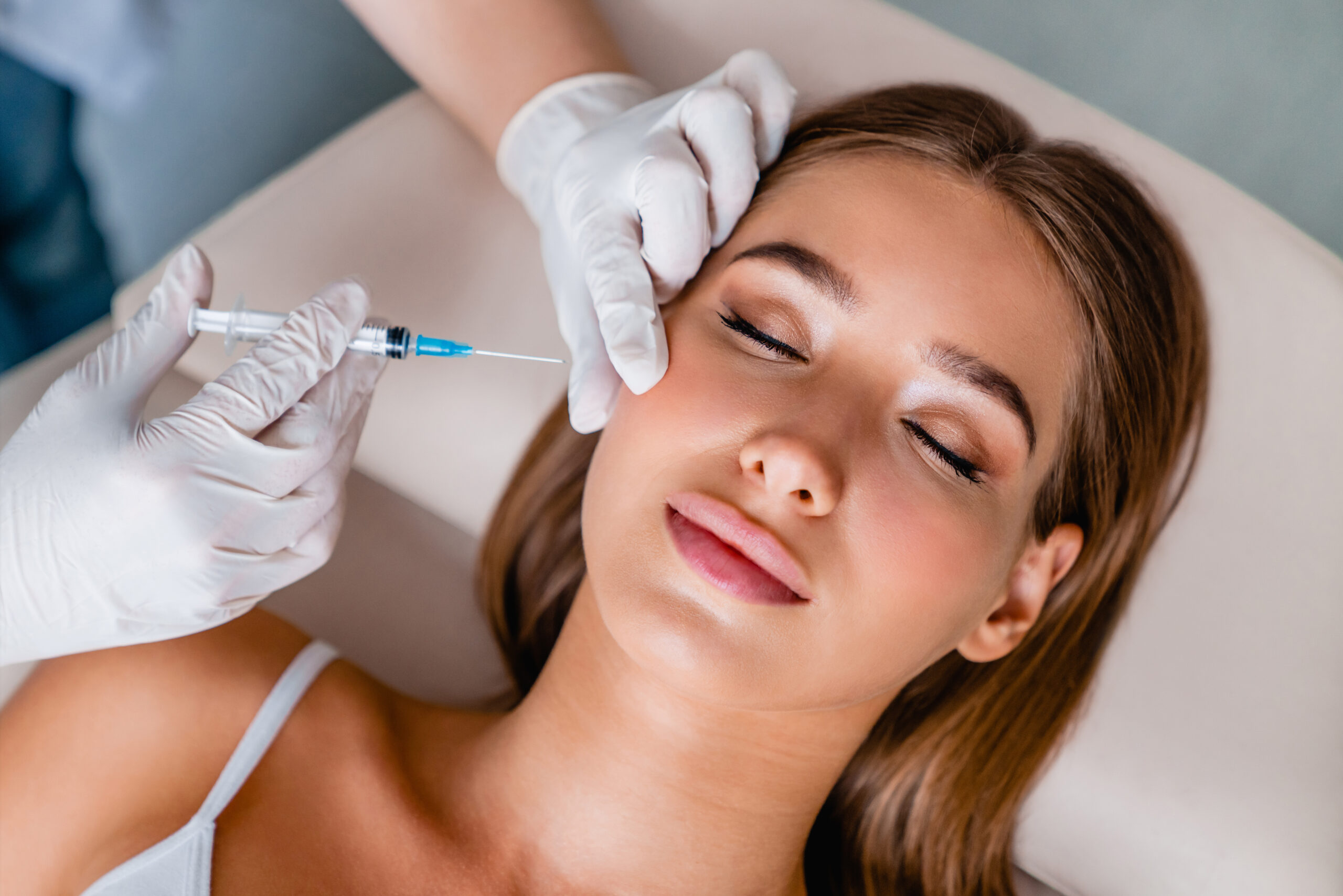 A woman getting an injection in her face.